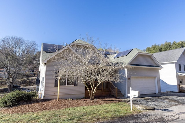 view of front property featuring a garage and solar panels