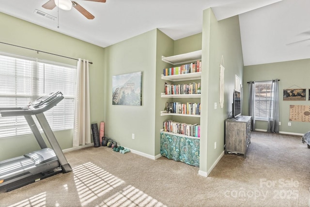 workout area with light colored carpet and ceiling fan