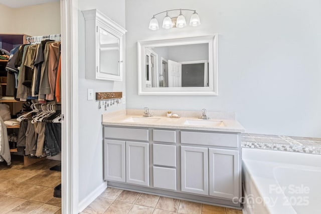 bathroom with vanity, tile patterned flooring, and a bathtub