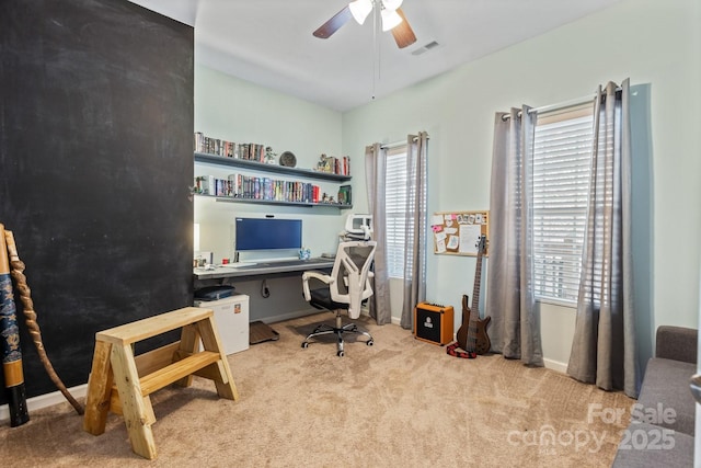 office with light colored carpet and ceiling fan