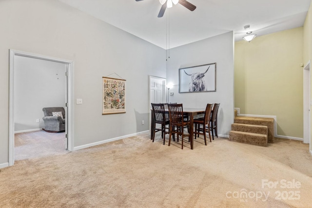 dining space with carpet and ceiling fan