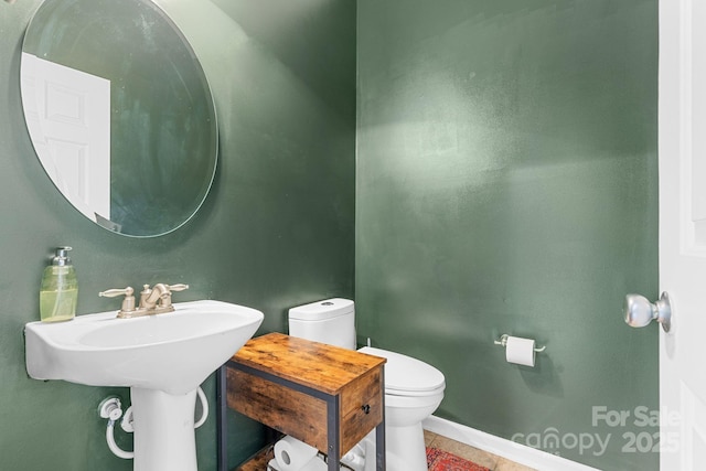 bathroom featuring tile patterned flooring and toilet