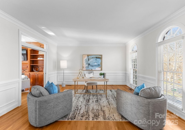 office space with ornamental molding, a wealth of natural light, and wood finished floors