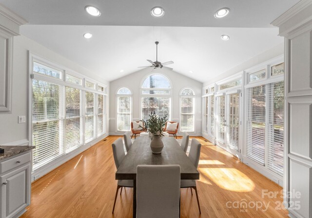 sunroom with vaulted ceiling and a ceiling fan