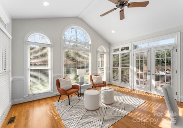 sunroom / solarium featuring visible vents, vaulted ceiling, and a ceiling fan