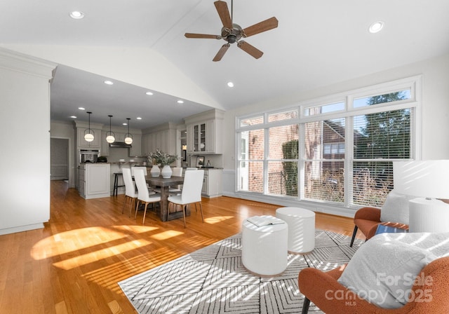 living area featuring light wood-style flooring, high vaulted ceiling, a ceiling fan, and recessed lighting