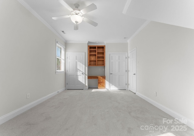 unfurnished bedroom with a ceiling fan, baseboards, crown molding, and light colored carpet