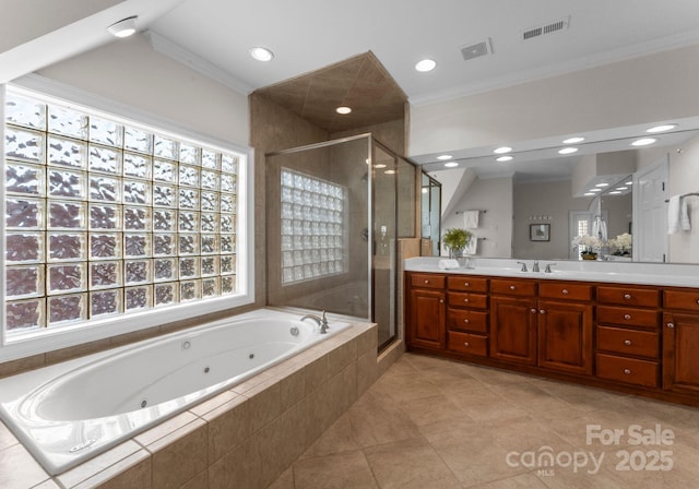 full bathroom featuring ornamental molding, a stall shower, vanity, and visible vents