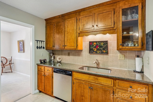 406 Brief Rd W, Indian Trail, NC 28079 - kitchen featuring dishwasher, glass insert cabinets, brown cabinetry, and a sink