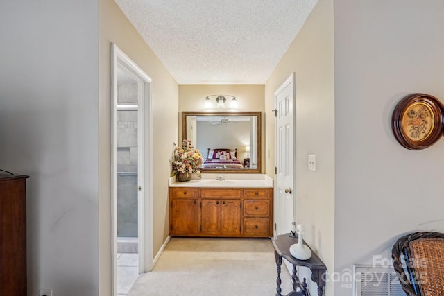 406 Brief Rd W, Indian Trail, NC 28079 - full bathroom with connected bathroom, vanity, and a textured ceiling