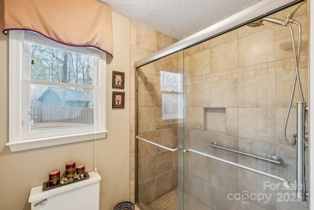 406 Brief Rd W, Indian Trail, NC 28079 - full bath with a stall shower, a textured ceiling, and toilet