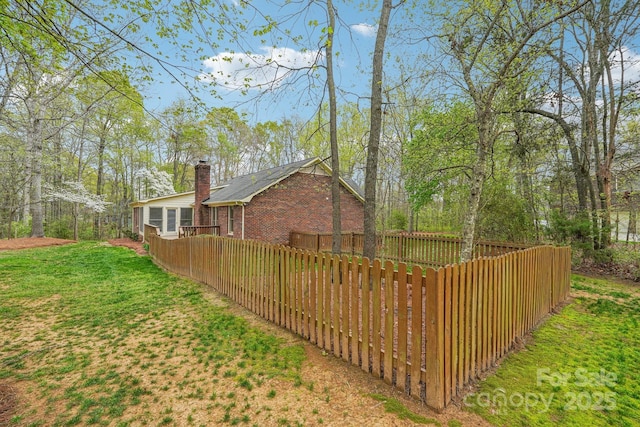 406 Brief Rd W, Indian Trail, NC 28079 - view of home's exterior with a lawn, brick siding, and fence