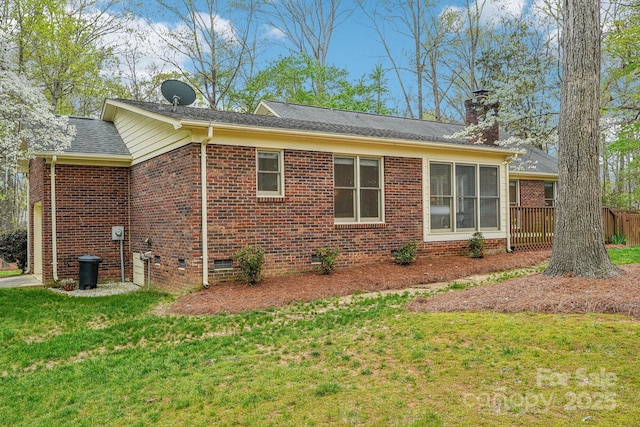 406 Brief Rd W, Indian Trail, NC 28079 - view of home's exterior featuring crawl space, a chimney, fence, a yard, and brick siding