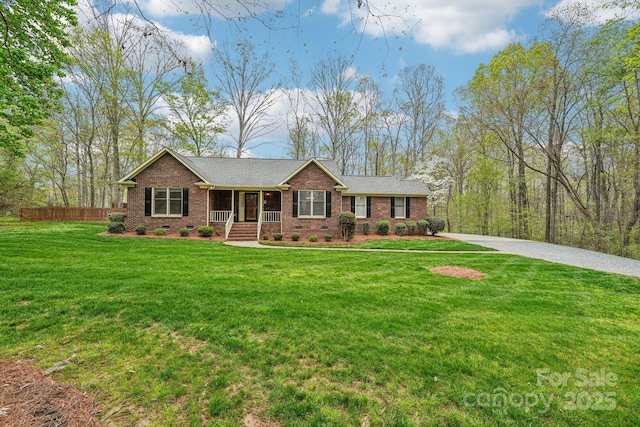 406 Brief Rd W, Indian Trail, NC 28079 - single story home featuring brick siding, a porch, a front yard, and fence