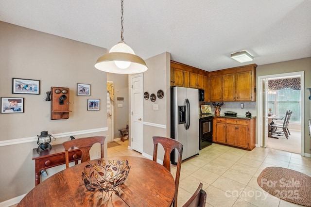 406 Brief Rd W, Indian Trail, NC 28079 - dining room with a textured ceiling, baseboards, and light tile patterned floors