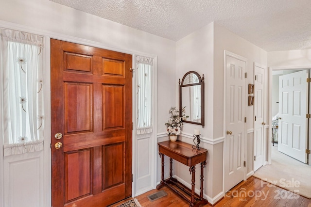 406 Brief Rd W, Indian Trail, NC 28079 - entrance foyer with visible vents, a textured ceiling, and light wood finished floors