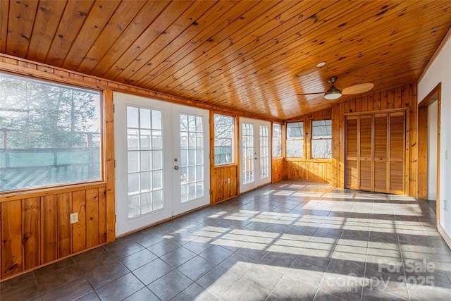 unfurnished sunroom featuring wood ceiling, vaulted ceiling, french doors, and ceiling fan