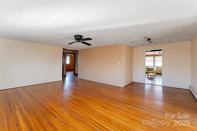 spare room with ceiling fan and hardwood / wood-style floors