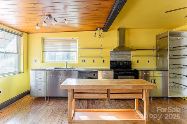 kitchen with wood ceiling, wall chimney exhaust hood, wood-type flooring, and black appliances