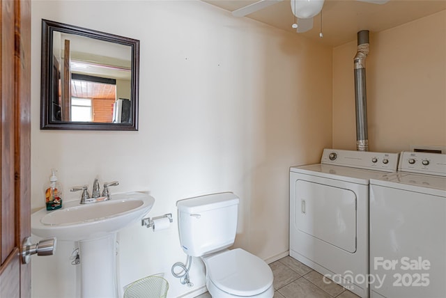 bathroom with separate washer and dryer, ceiling fan, tile patterned flooring, and toilet