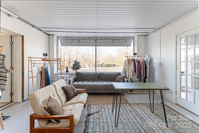 living room with plenty of natural light and concrete flooring