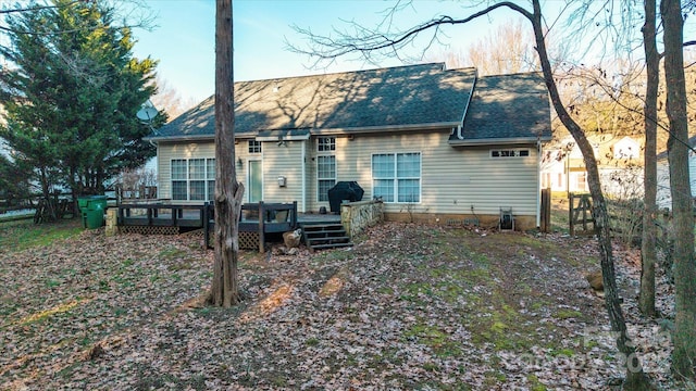 rear view of house featuring a wooden deck