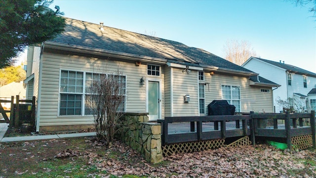 back of house with a deck