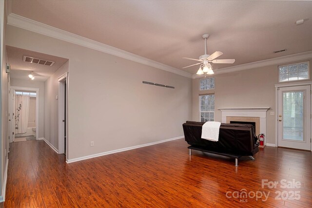 living room featuring dark wood-type flooring, ceiling fan, and ornamental molding