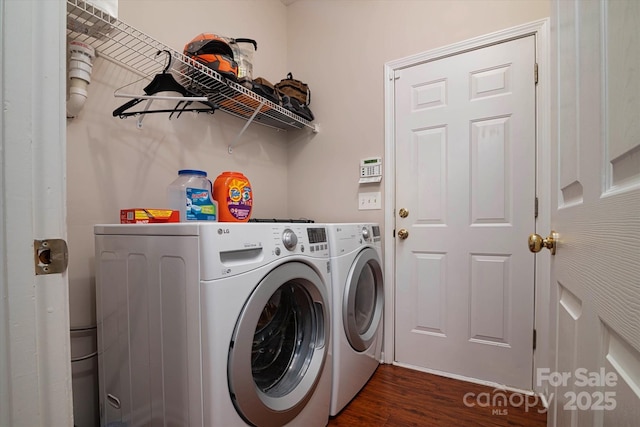 laundry area featuring dark hardwood / wood-style flooring and washer and clothes dryer