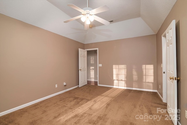 spare room with lofted ceiling, carpet floors, and ceiling fan