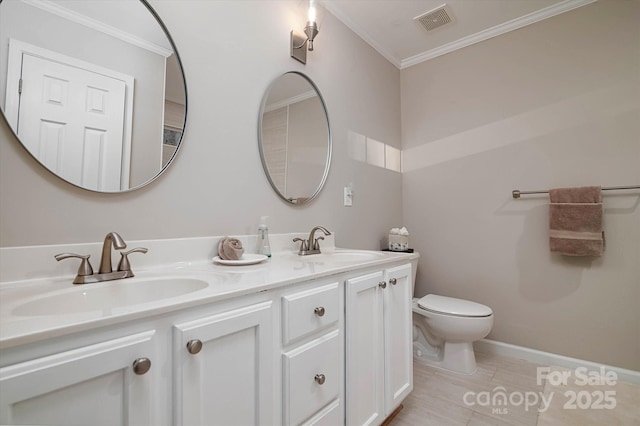 bathroom featuring ornamental molding, vanity, and toilet