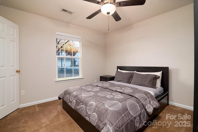 bedroom featuring ceiling fan and carpet