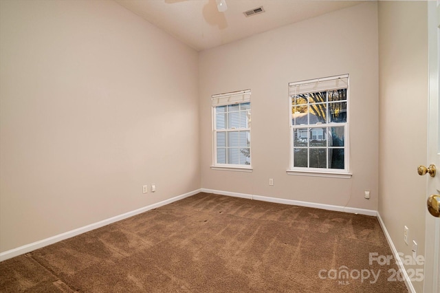 carpeted spare room with ceiling fan