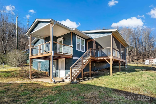 rear view of property with a patio and a lawn