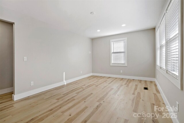 unfurnished room with light wood-type flooring