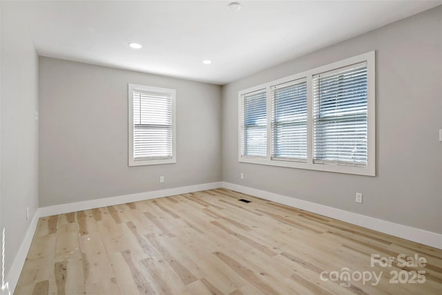 empty room with light hardwood / wood-style floors