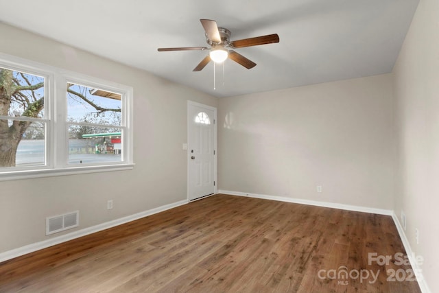 empty room with hardwood / wood-style flooring and ceiling fan