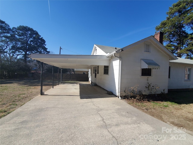 view of side of property featuring a carport