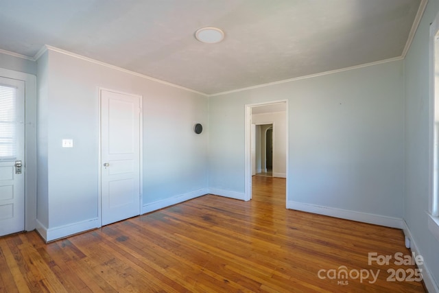 unfurnished room with crown molding and hardwood / wood-style floors