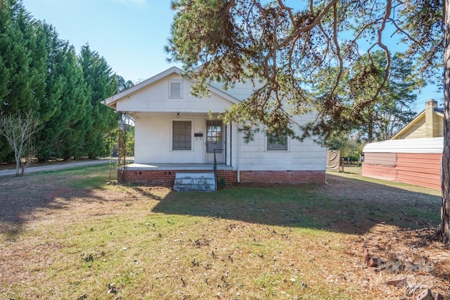 bungalow with a porch and a front yard