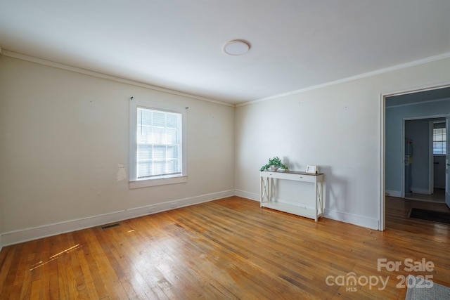 unfurnished room with crown molding and hardwood / wood-style floors