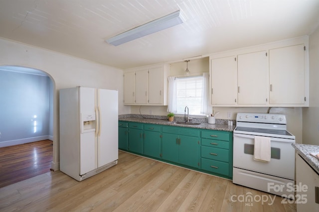 kitchen with sink, white appliances, white cabinets, and light wood-type flooring