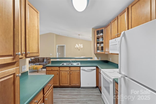 kitchen featuring vaulted ceiling, sink, a chandelier, white appliances, and light hardwood / wood-style flooring