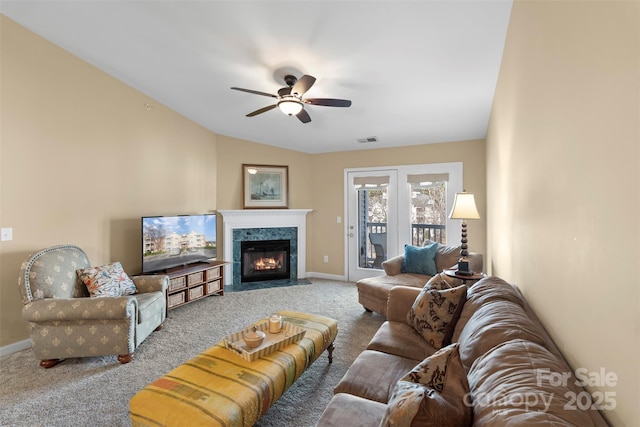 living room featuring ceiling fan, carpet flooring, and vaulted ceiling