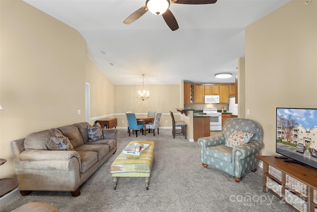 carpeted living room featuring vaulted ceiling and ceiling fan with notable chandelier