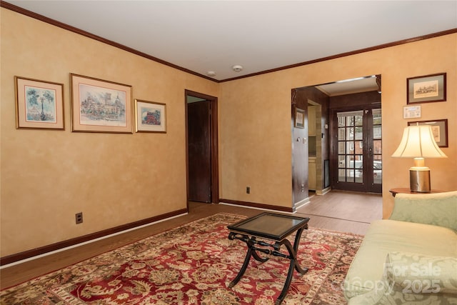 living room featuring light hardwood / wood-style flooring, ornamental molding, and french doors