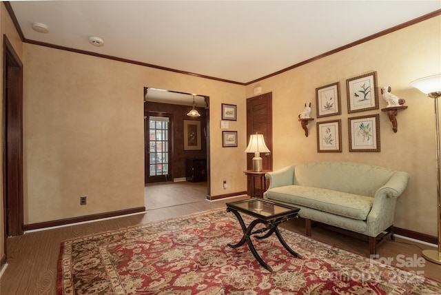 sitting room featuring crown molding and hardwood / wood-style floors