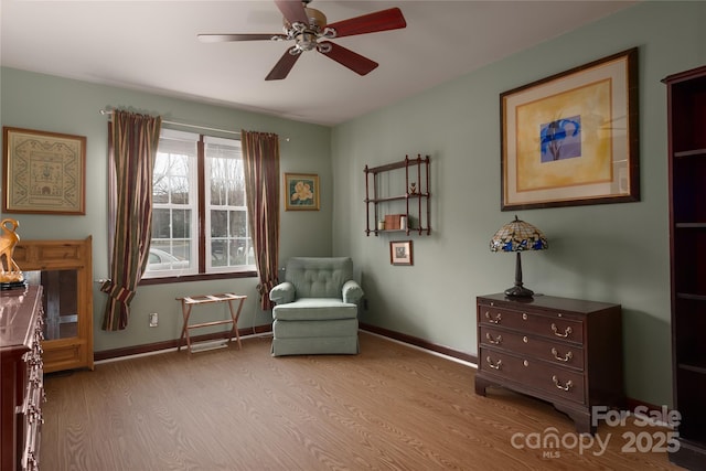 living area with ceiling fan and light hardwood / wood-style floors