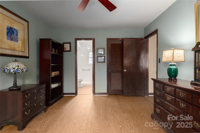 bedroom with a closet, connected bathroom, ceiling fan, and light hardwood / wood-style flooring