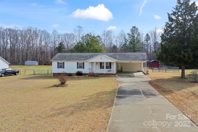 single story home featuring a porch, a carport, and a front lawn